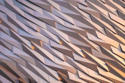 Closeup of the titanic building facade, parametric pattern, angular shapes, architectural photography, golden hour lighting, sharp focus on details, high resolution, high detail, super realistic,