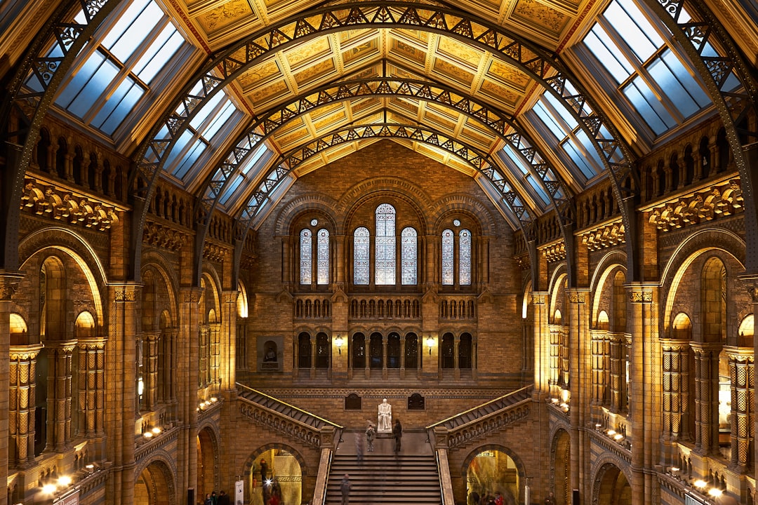 The Natural History Museum in London, featuring the iconic grand staircase and stained glass windows, stands as an architectural marvel of Gothic architecture. The museum’s vast space holds one million artifacts from around planet Earth, showcasing nature’s diversity through its sprawling collection. This scene captures the aweinspiring scale of natural history within these walls. This ultrarealistic photograph was captured in the style of high resolution digital photography using a Canon EOS R5 camera with a macro lens for intricate detail. –ar 128:85