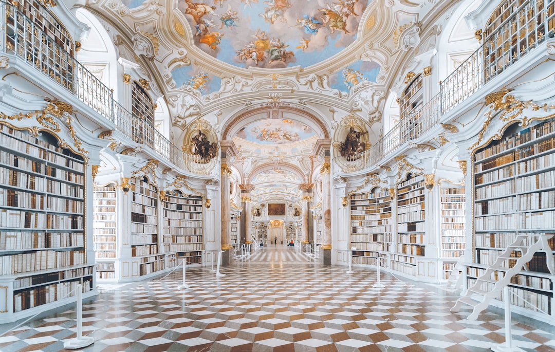 A photo of the admonũngium library in Austria, full height view, wide angle, white and gold color scheme, beautiful architecture, hyper realistic photography, award winning photoshooting