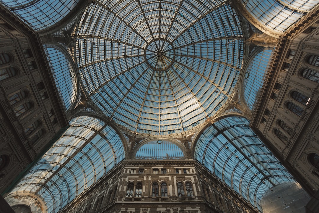 wide angle photo of the glass dome roof in sophisticated Galleria Uff’Ete, in naples italy, daylight, cinematic