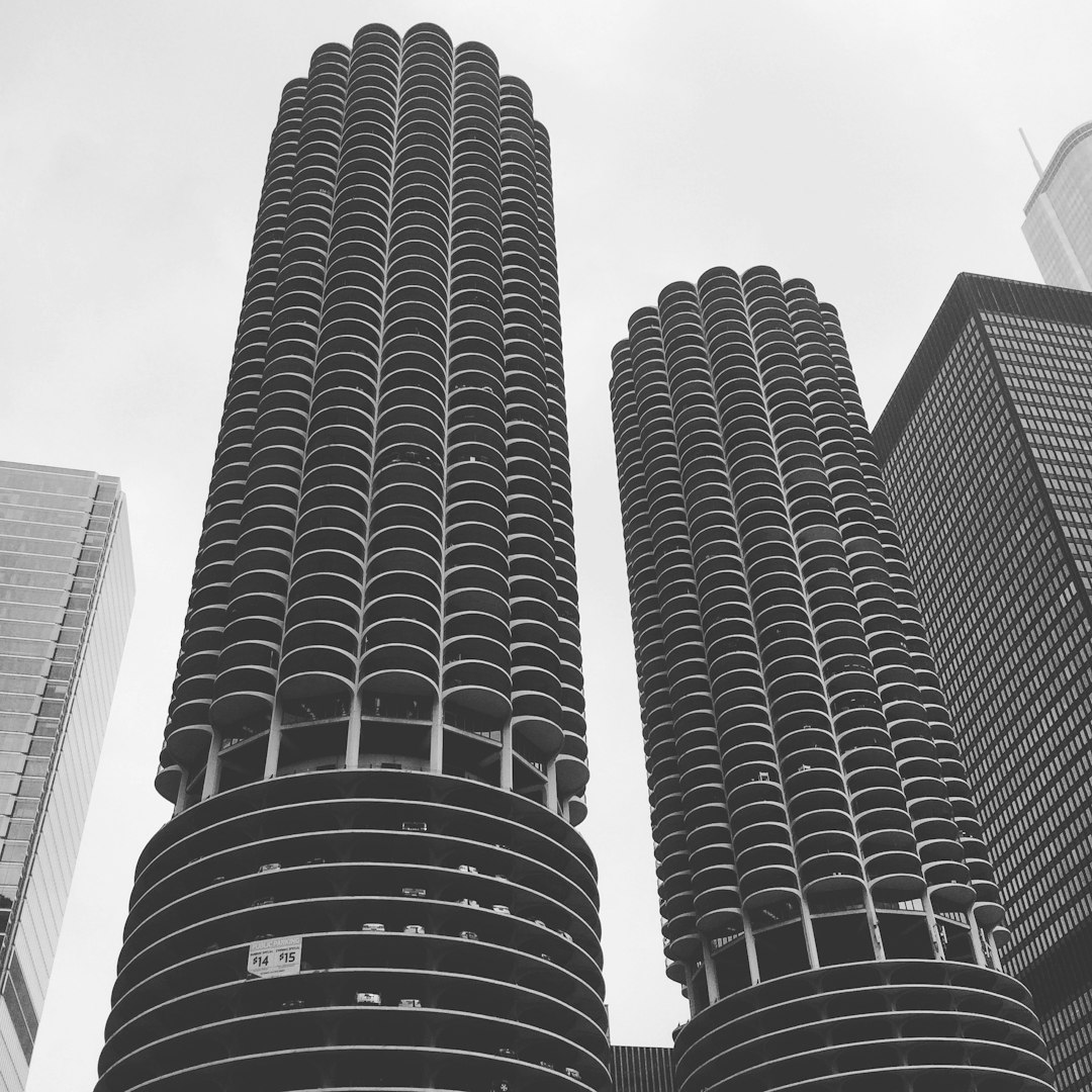 black and white photo of the three marina city towers in chicago, view from street level, looking up at them