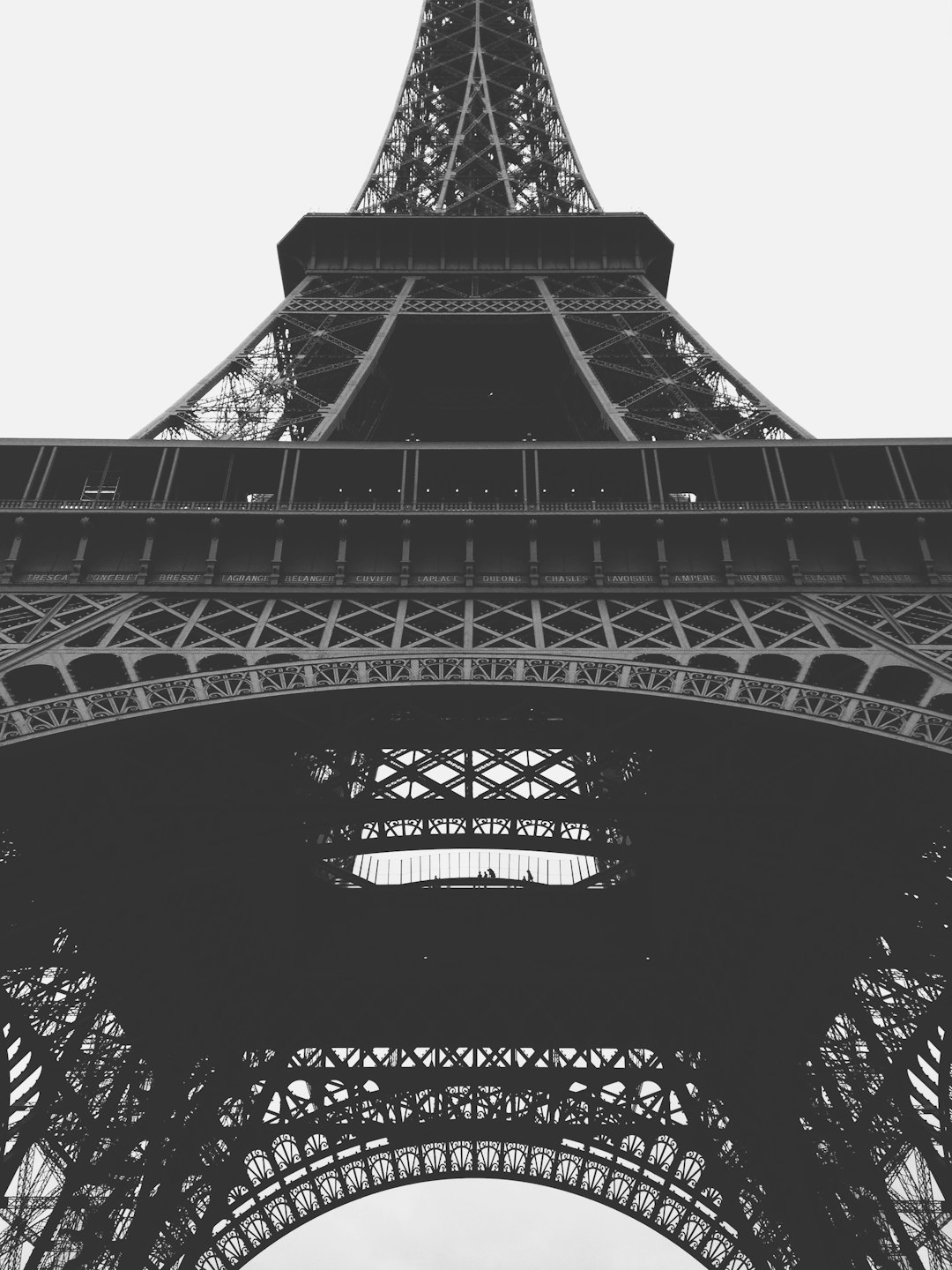 Black and white photography of the Eiffel Tower, low angle shot. The photograph is in the style of unsplash photography. –ar 3:4