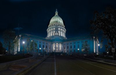 photograph of the state capital building in Madison, wisconsin, at nighttime, with blue lighting, using a centered composition and wide angle lens.