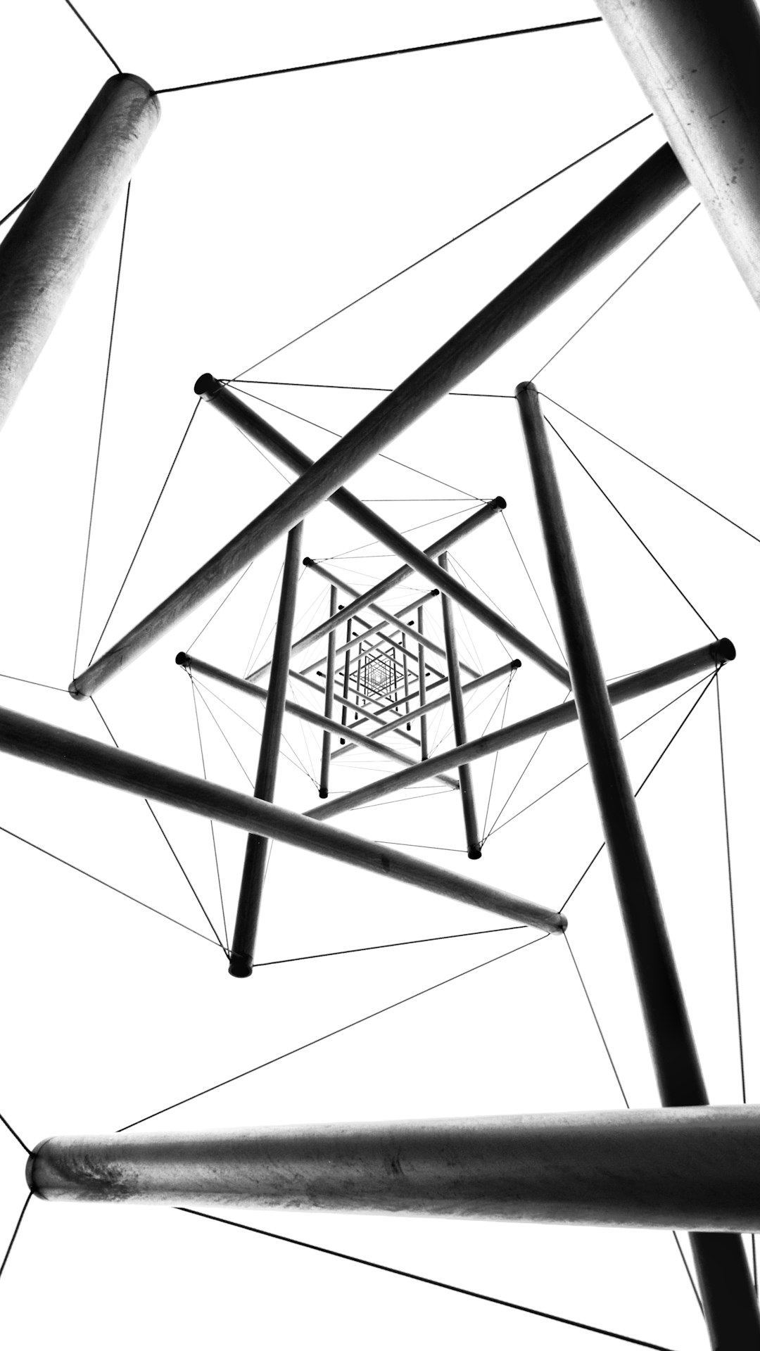 geometric minimalism, straight lines and triangles in black on white background, vertical pipes connected in the style of connected to each other with wire in the center of frame, symmetrical perspective, hyper realistic photography –ar 9:16