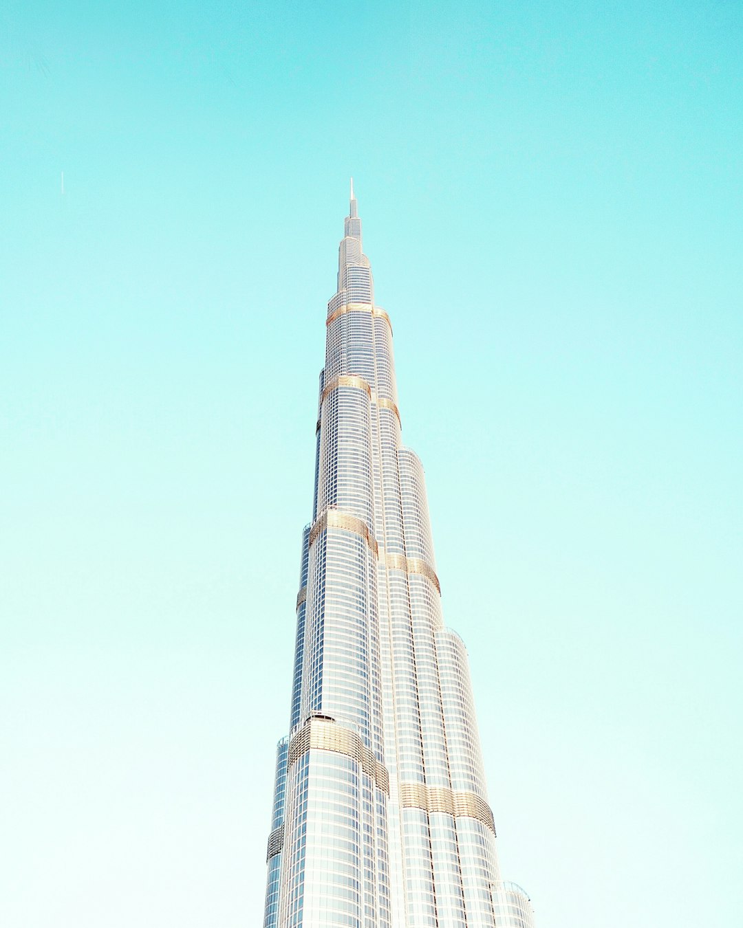 Photo of Burj Khalifa in Dubai, minimalistic aesthetic, pastel blue sky, travel photography, travelcore, Canon EOS R5. –ar 51:64