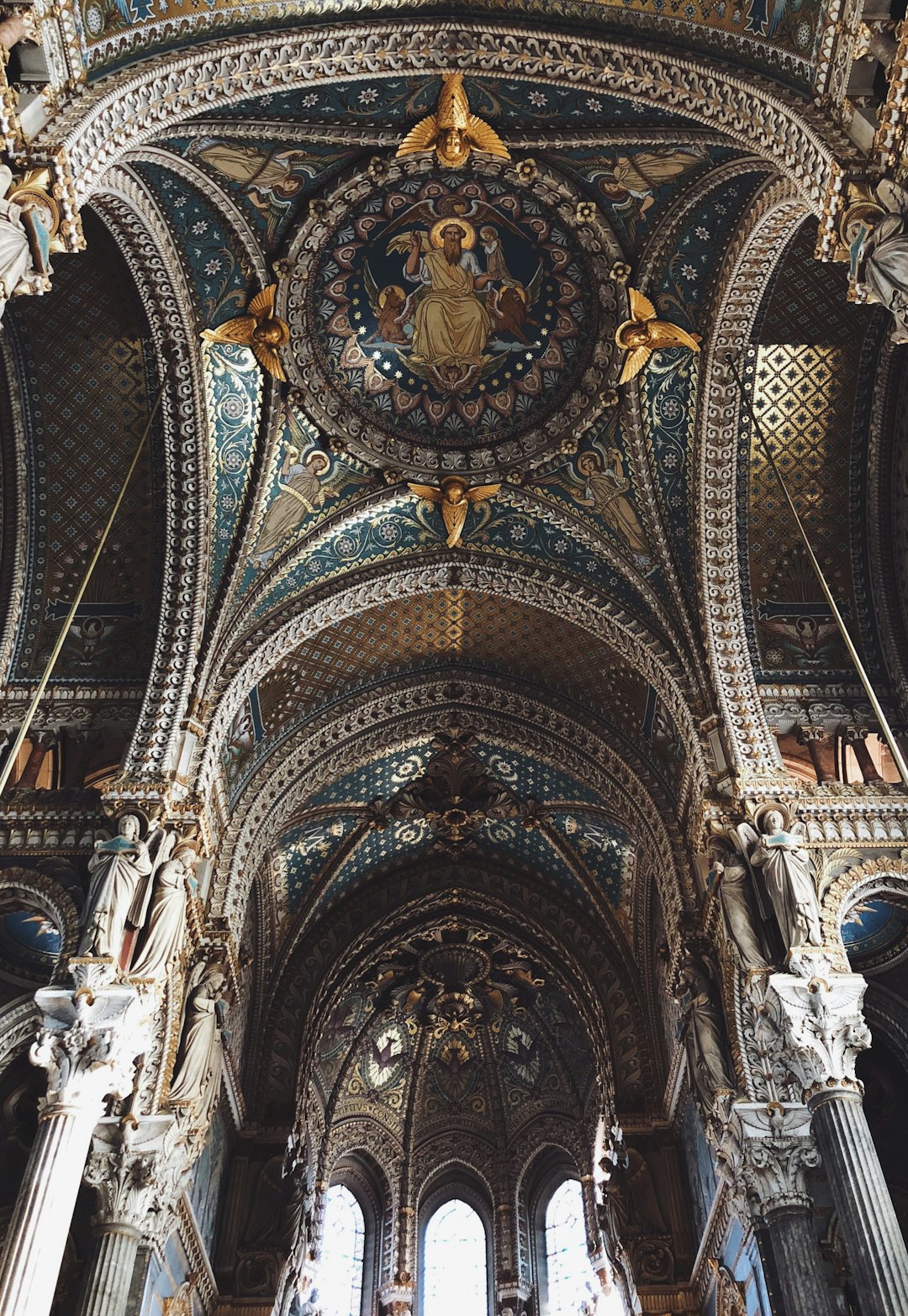 A stunning photo of the ceiling in an old French cathedral, adorned with intricate mosaics and arches, showcasing ornate architectural details that evoke grandeur and history. The photo focuses on architectural details in the style of old cathedrals. –ar 11:16