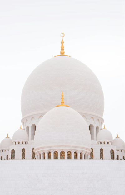 Photo of white domes and walls of the "moonscape" or "colossal white dome", in the style of Islamic, with gold details, on a clear sky background, captured from a low angle to emphasize its grandeur, isolated on a clean blank white background.