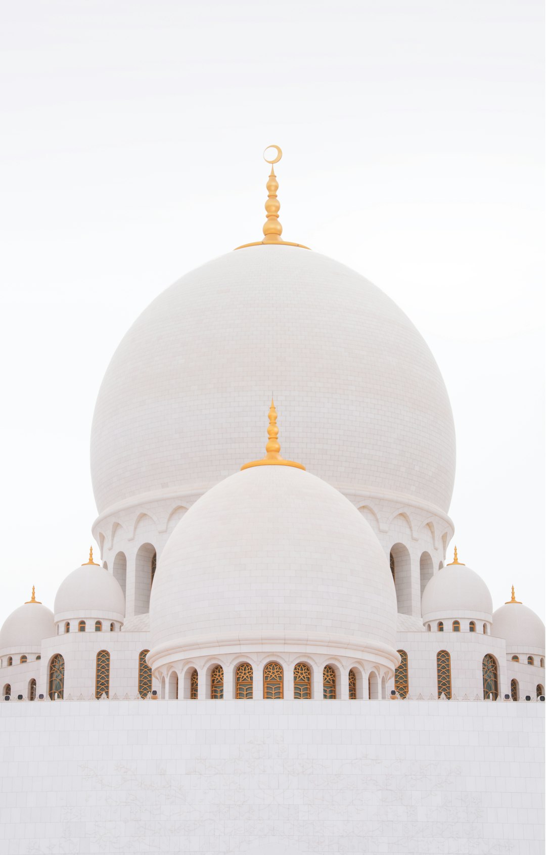 Photo of white domes and walls of the “moonscape” or “colossal white dome”, in the style of Islamic, with gold details, on a clear sky background, captured from a low angle to emphasize its grandeur, isolated on a clean blank white background.