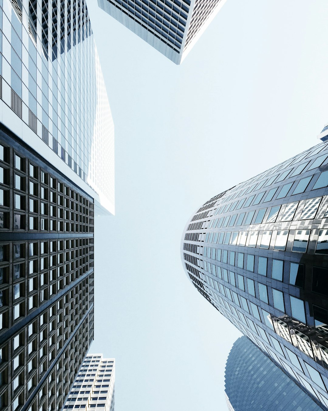 Modern skyscrapers, glass buildings, perspective view from the ground looking up at tall office towers, white sky, clear skies, daylight, high resolution photography, architectural magazine cover photo