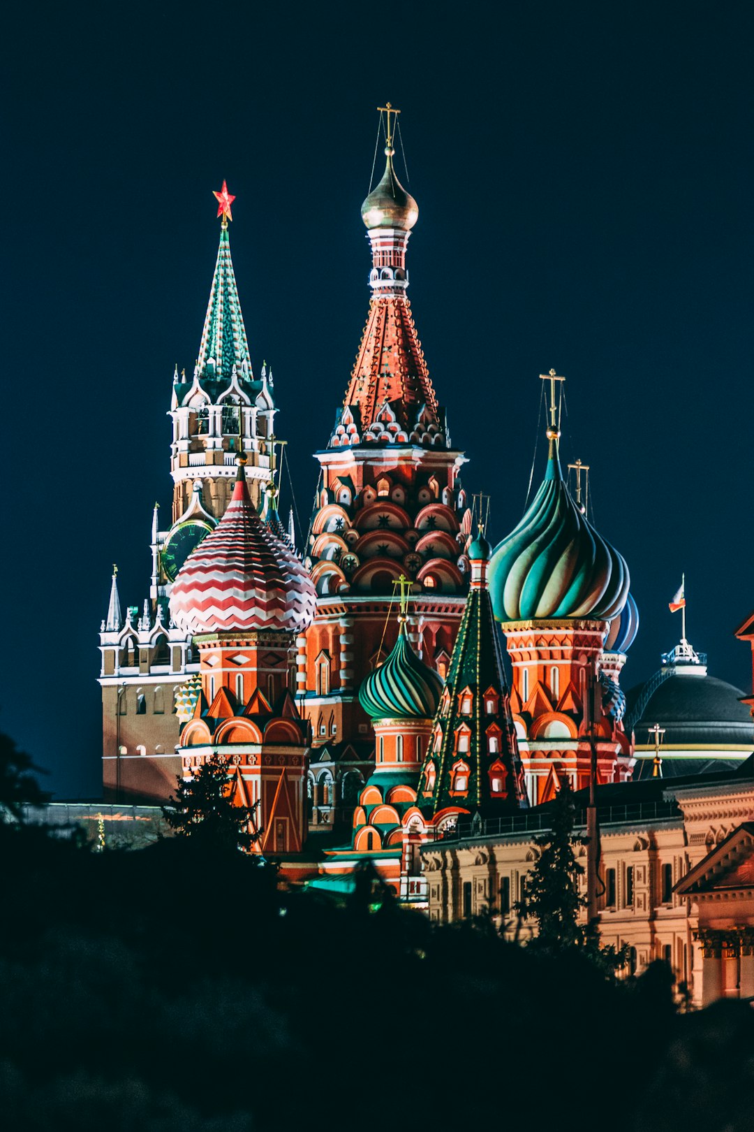 St Basil’s Cathedral, Red Square in Moscow at night, Russian architecture with vibrant colors, illuminated domes, a lively atmosphere, historic buildings under the night sky, the Russian flag, travel photography captured with a high resolution Canon EOS camera and wideangle lens, dynamic lighting brought out colorful details in the architecture, perfect composition in the style of architecture photography. –ar 85:128