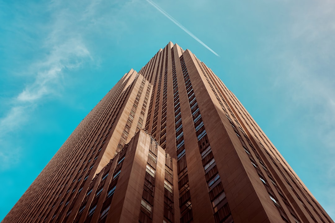 photo of the rockfist building in new york, low angle shot, blue sky, cinematic –ar 128:85