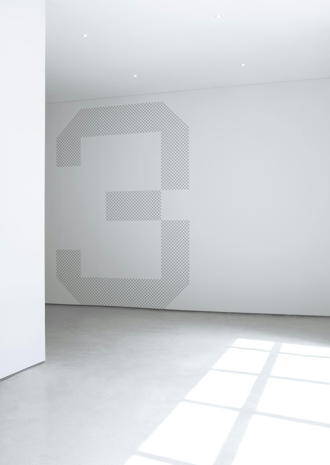 A large white wall with the number “3” in an interesting and modern font, with a light gray dot pattern on it, in a minimalist style, with large space between elements, with light from the window on the left side, with a light floor and white walls.