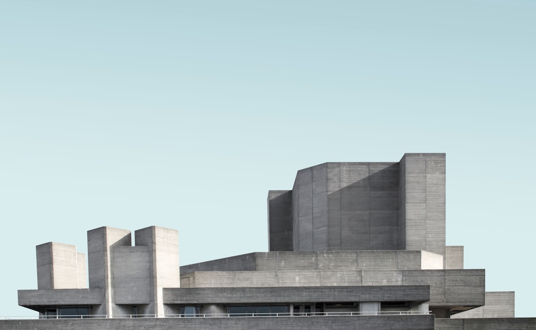 photograph of the national theatre in london, designed by tadao andresson, made from concrete, minimalist architecture photography, blue sky background, archdaily, hyper realistic –ar 64:39