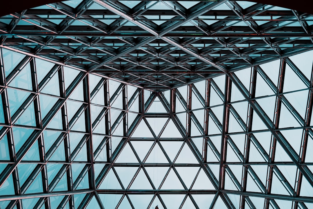 Top view of a glass and steel structure with a triangular pattern, interior shot in the style of Canon EOS R5. –ar 128:85