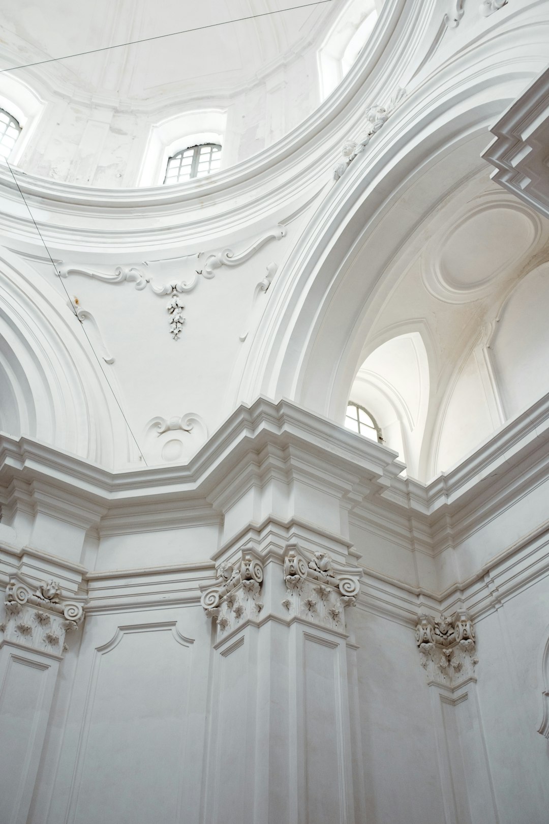 Low angle shot, interior of an old church with white walls and domed ceiling, architectural photography, architectural style, architecture magazine photography, highly detailed, sharp focus, high resolution. –ar 85:128