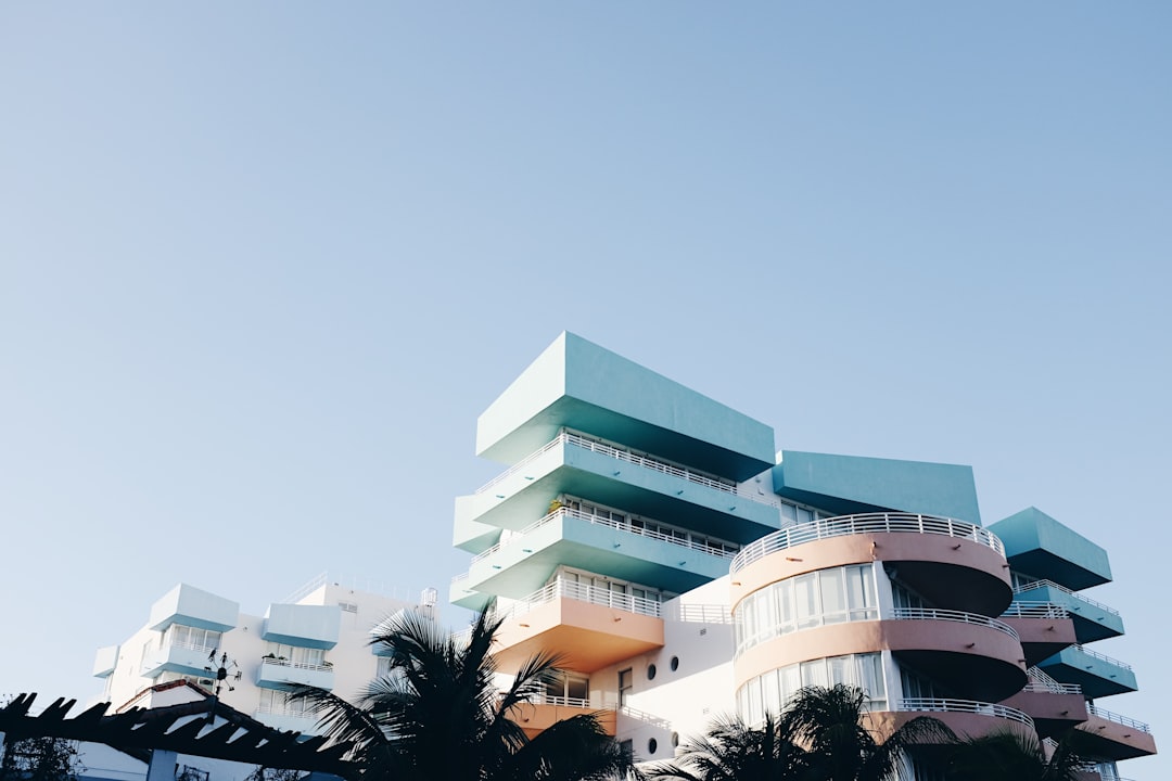 A photograph of an art deco building in Miami Beach, with pastel colors and a minimal aesthetic perspective. The photograph is in the style of a minimal aesthetic.