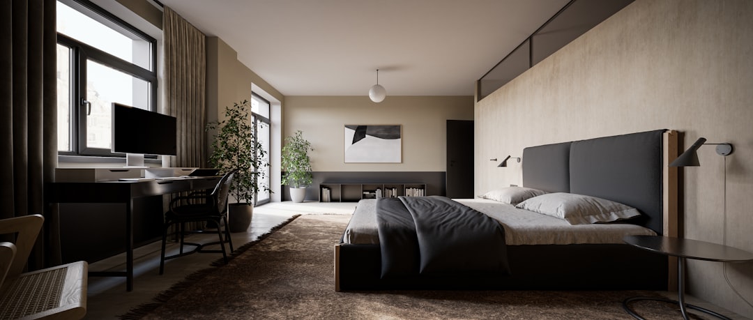 A modern bedroom with a black bed, grey and beige walls, a wooden desk on the left side of the room, a large window on the front wall, a plant in the corner, a carpeted floor, and a low ceiling. The photorealistic rendering is in the style of cinematic. –ar 64:27