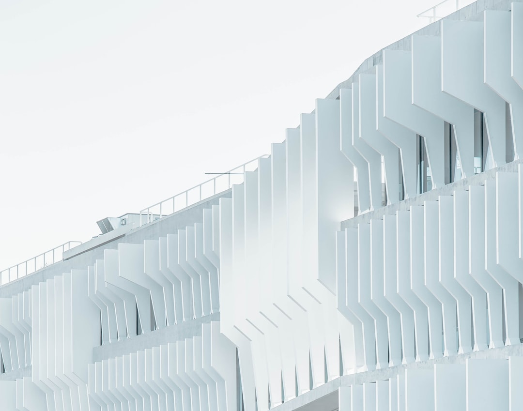 white facade building, closeup view, white background, white elements, futuristic architecture, angular shapes, parametric design, high detail, hyperrealistic, photography, cinematic –ar 32:25