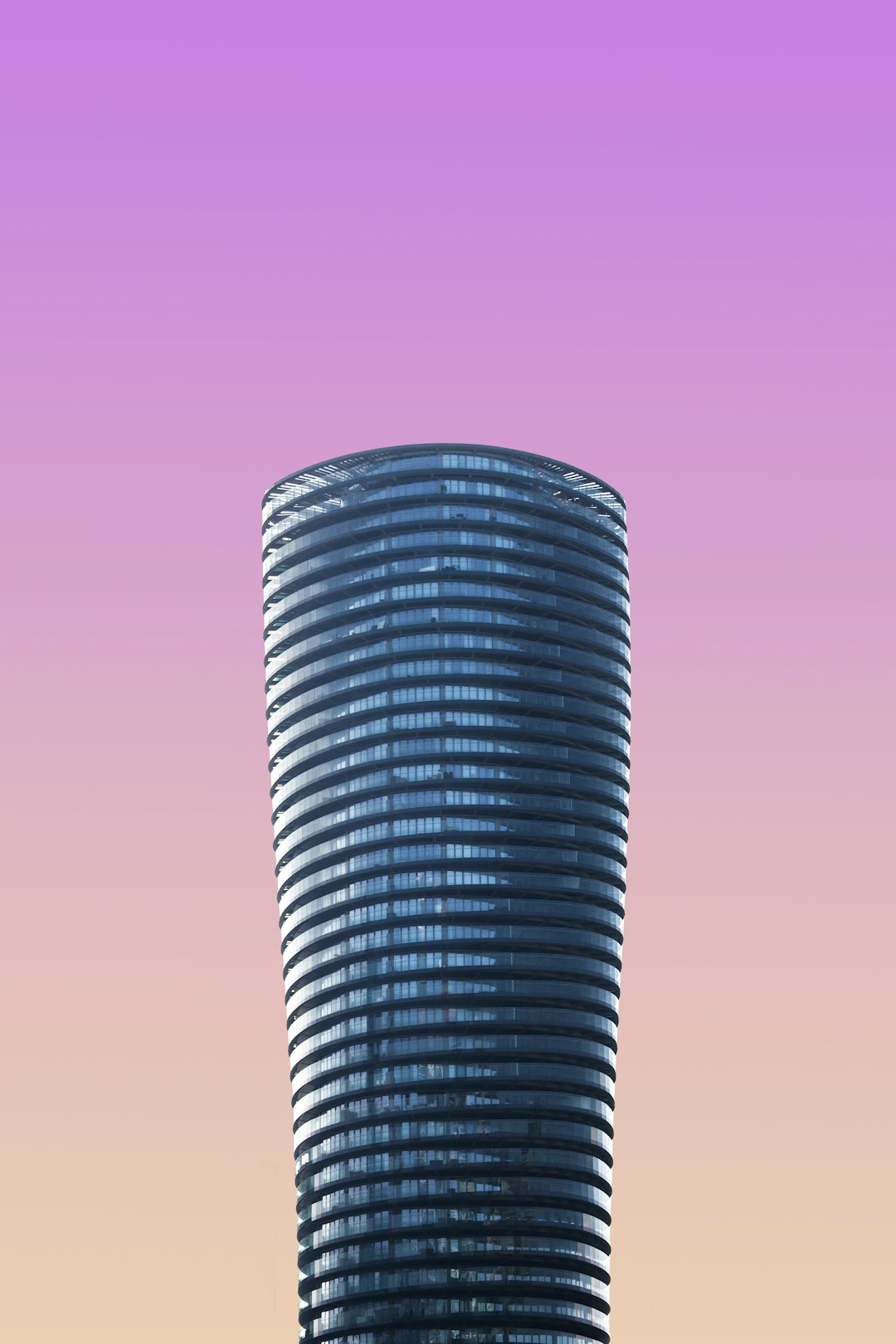 A sleek, modern skyscraper against the gradient sky of dawn or dusk, symbolizing innovation and progress in urban architecture. The tall building has circular windows that reflect light, creating an illusionary effect of its height. The sky is pastel pink to purple, adding depth and contrast to the scene. The focus on the skyscraper should be sharp with a shallow depth of field, highlighting it as a focal point against the soft background. –ar 85:128