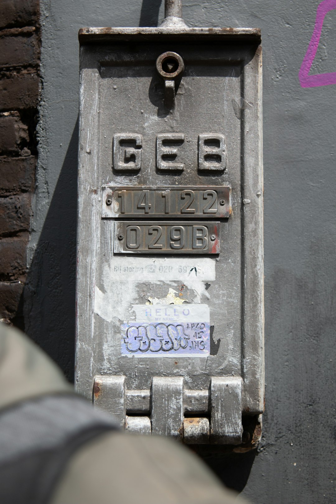 A photo of the text “642” written on an old grey metal electric box, with some stickers stuck to it in a New York City street. The text appears to be in the style of street art. –ar 85:128