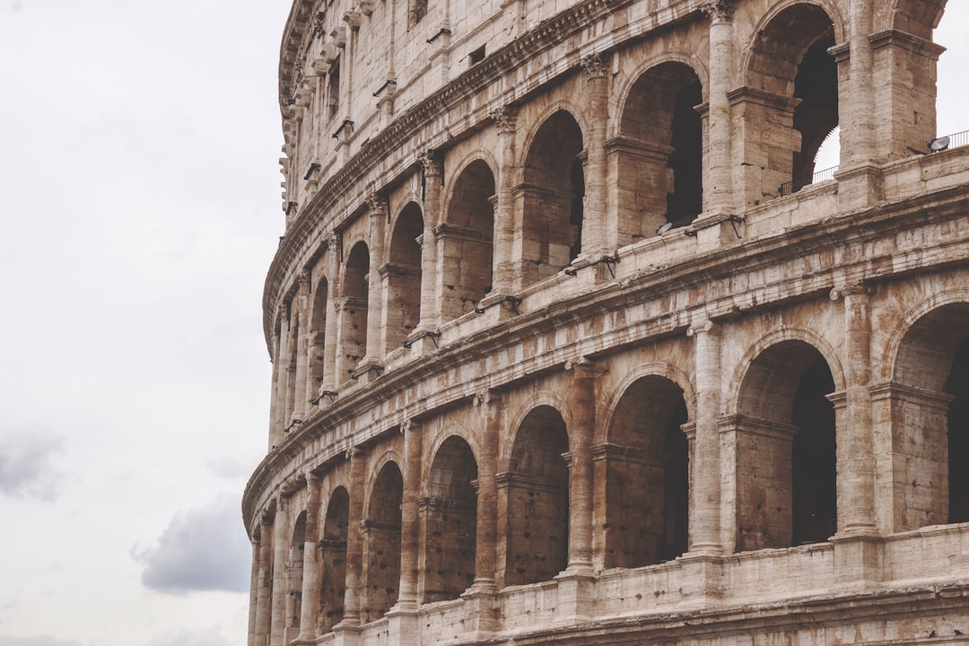 close up photo of the colosseum in Rome, white sky, grey day, muted tones, natural light, cinematic –ar 128:85