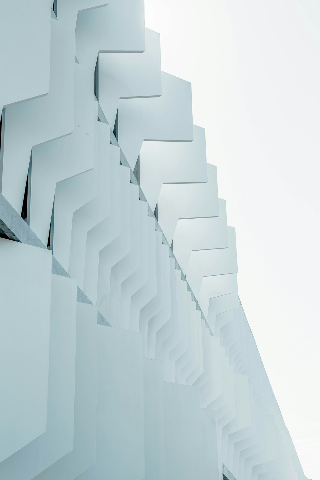 white background, white wall, abstract futuristic building made of angular shapes in the style of minimalistic.