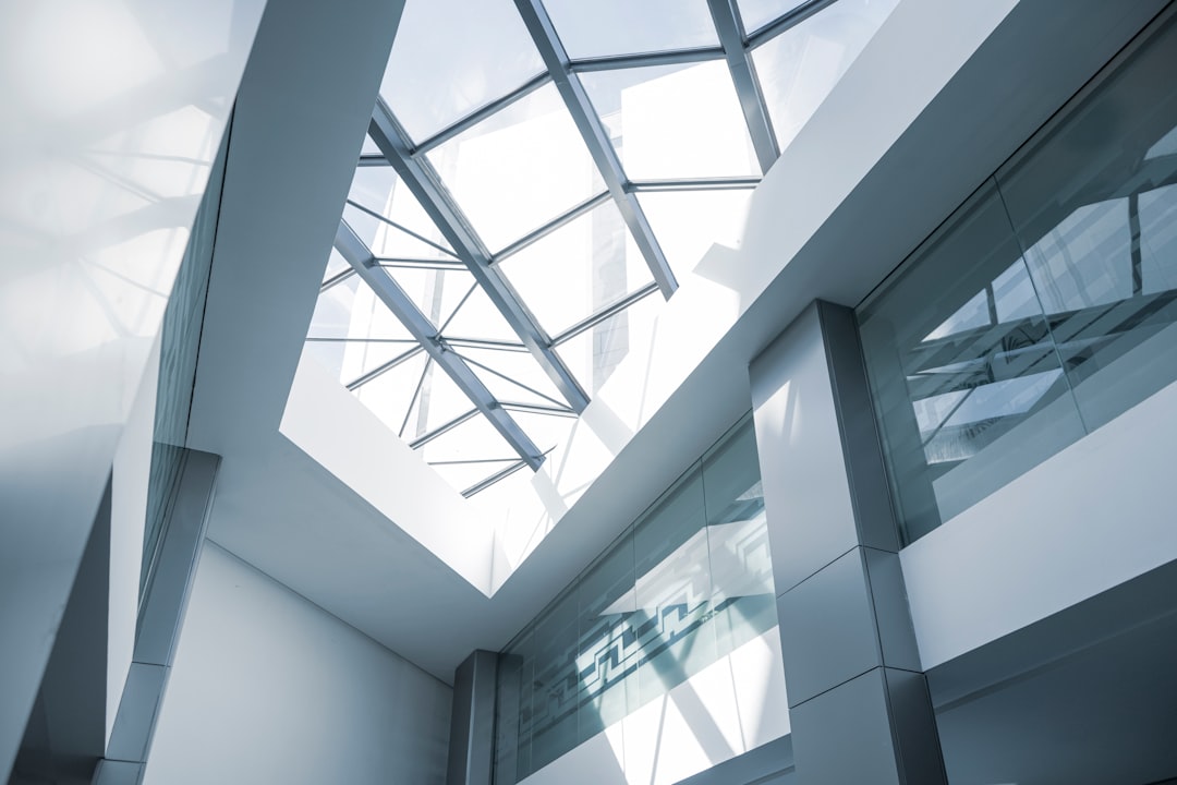 A modern building interior with skylights, featuring clean lines and glass windows for natural light