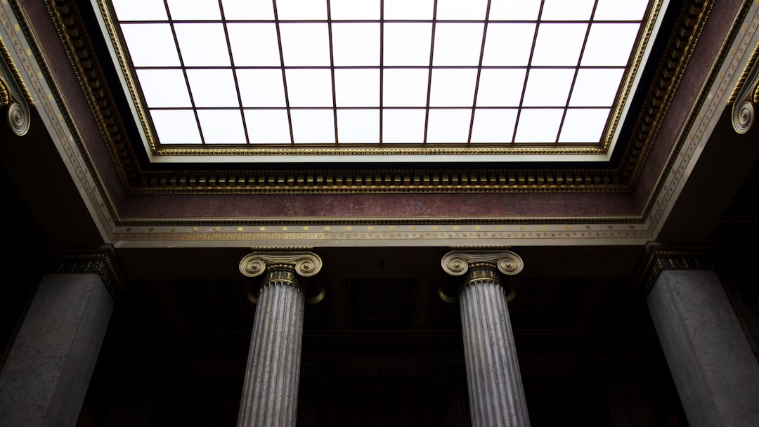 photo of an empty museum ceiling with Greek columns, large skylight, dark room, architectural photography, high resolution, cinematic, shot on canon eos r5