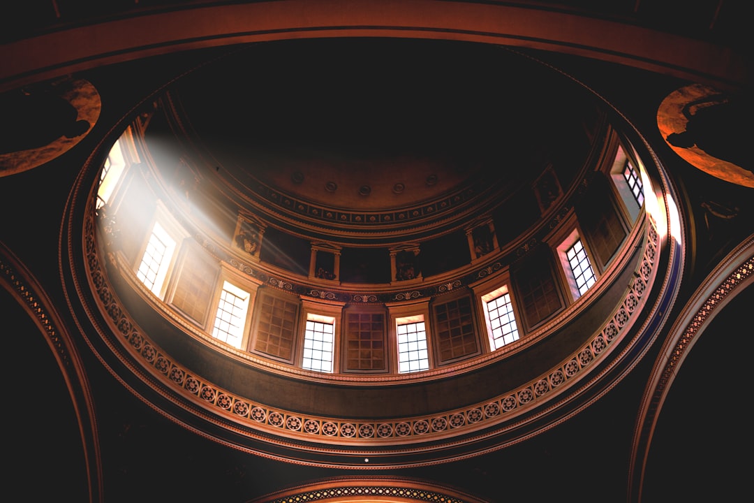 A low angle shot of the dome in an old church, photo taken with Sony Alpha A7 III, photo realistic, hyperrealistic, cinematic, beautiful light and shadow, wide angle lens, f/28, in the style of Fujifilm Superia. –ar 128:85