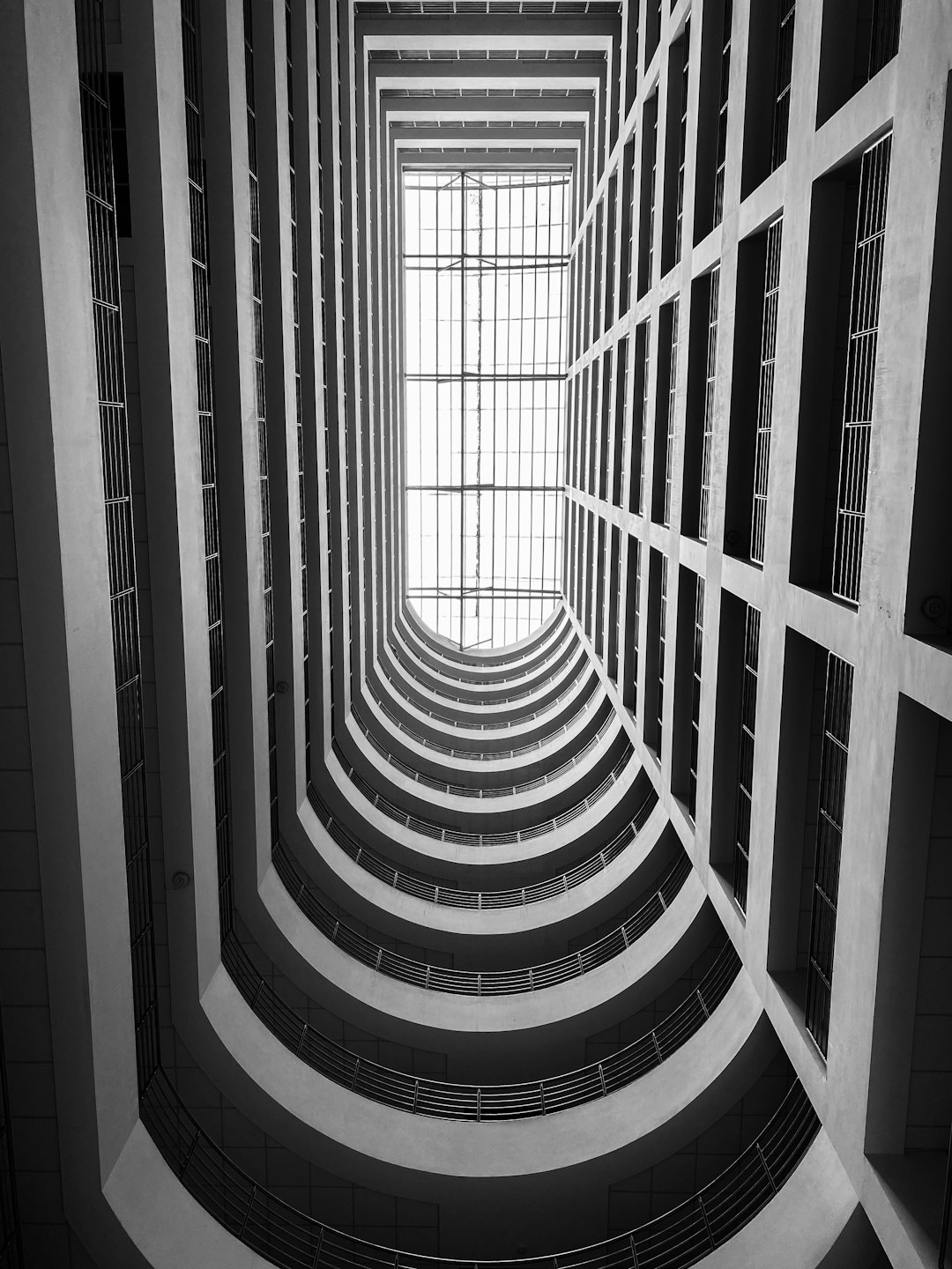 The interior of the HighRise Building in Shanghai has a symmetrical composition captured in monochrome photography with an architectural photography wide angle shot showcasing the architectural style in the style of award-winning architecture photographer [Iwan Baan](https://goo.gl/search?artist%20Iwan%20Baan), who used a Hasselblad X2D camera. –ar 3:4