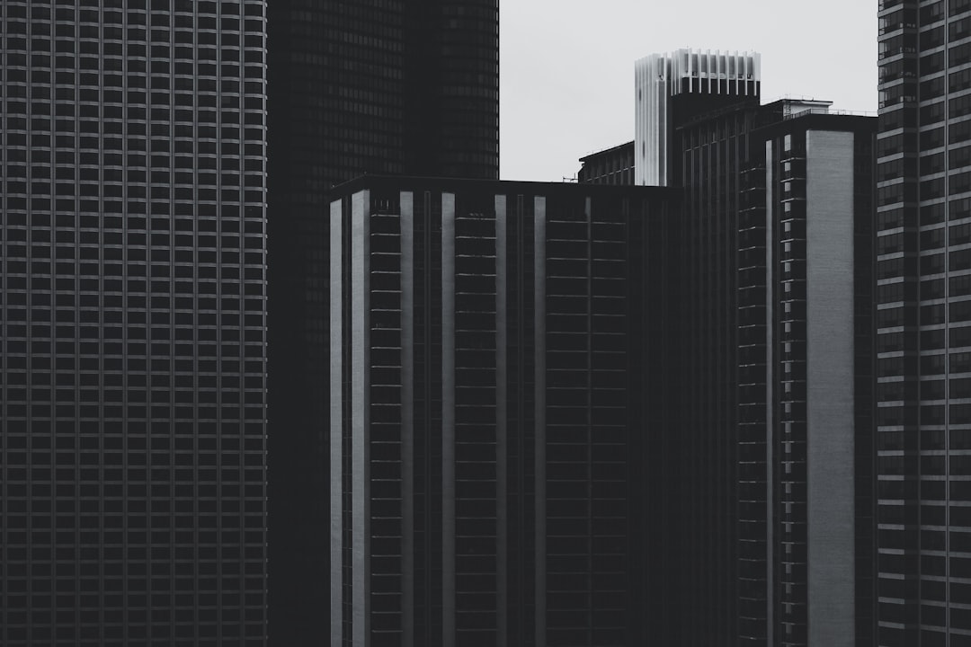 modern skyscrapers, minimalism, black and white photography, high contrast, grainy texture, fujifilm xh2s