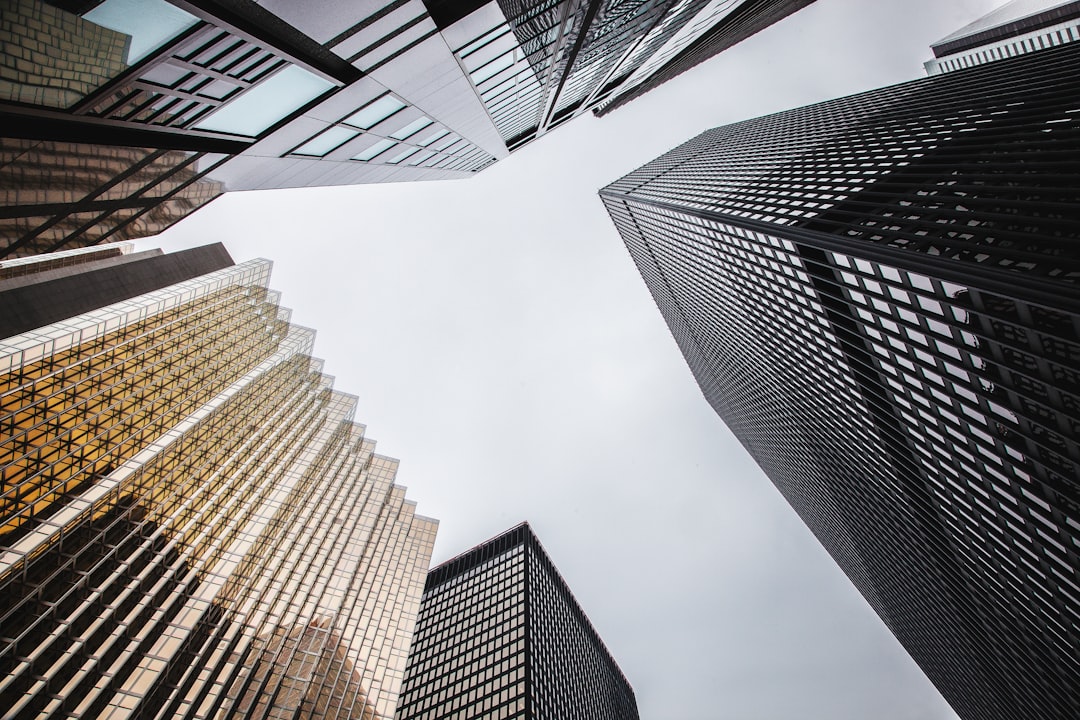 Low angle photo of tall skyscrapers in downtown Toronto, grey sky, lowangle shot, skyscraper buildings, geometric architecture shapes, high resolution photography, hyper realistic, sharp focus, natural lighting, cinematic, professional color grading, –ar 128:85