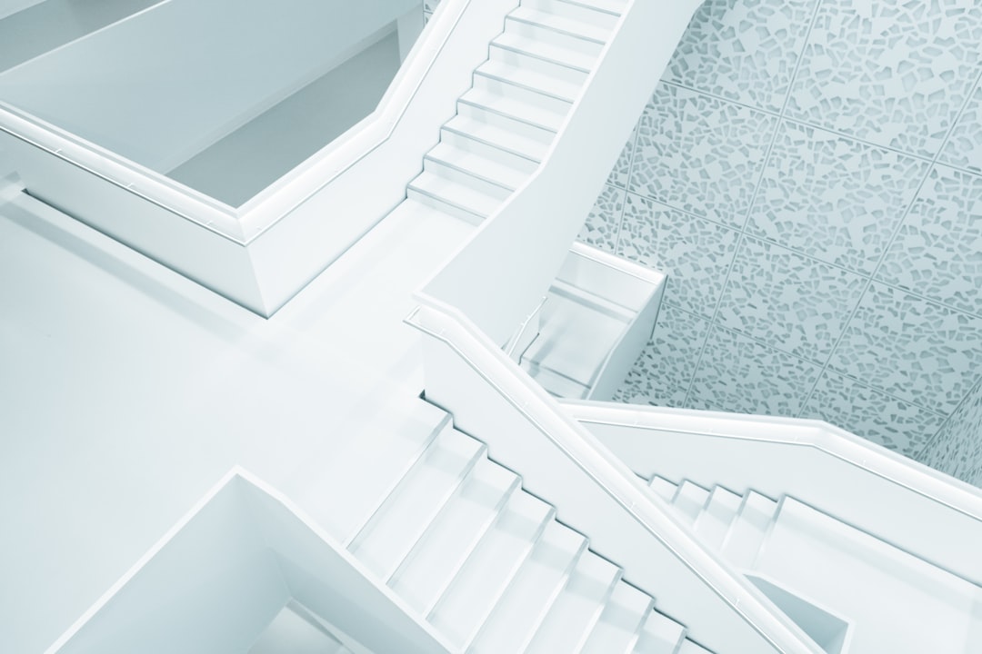 White staircase with geometric patterns, aerial view, high resolution photography, in the style of a professional color grader, soft shadows, no contrast, clean sharp focus, digital photography –ar 128:85