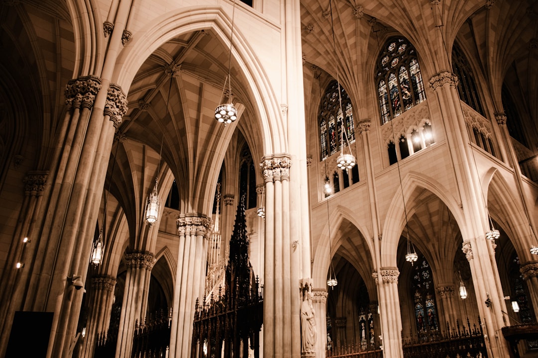 Stoic aesthetic photography, inside st patricks cathedral, sepia filter, arches and columns, stained glass windows,