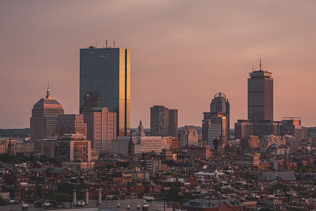 photograph of the city skyline of Boston, dark pink sky, tall buildings, tall skyscrapers, cityscape, 20mm lens, golden hour, back boston –ar 128:85