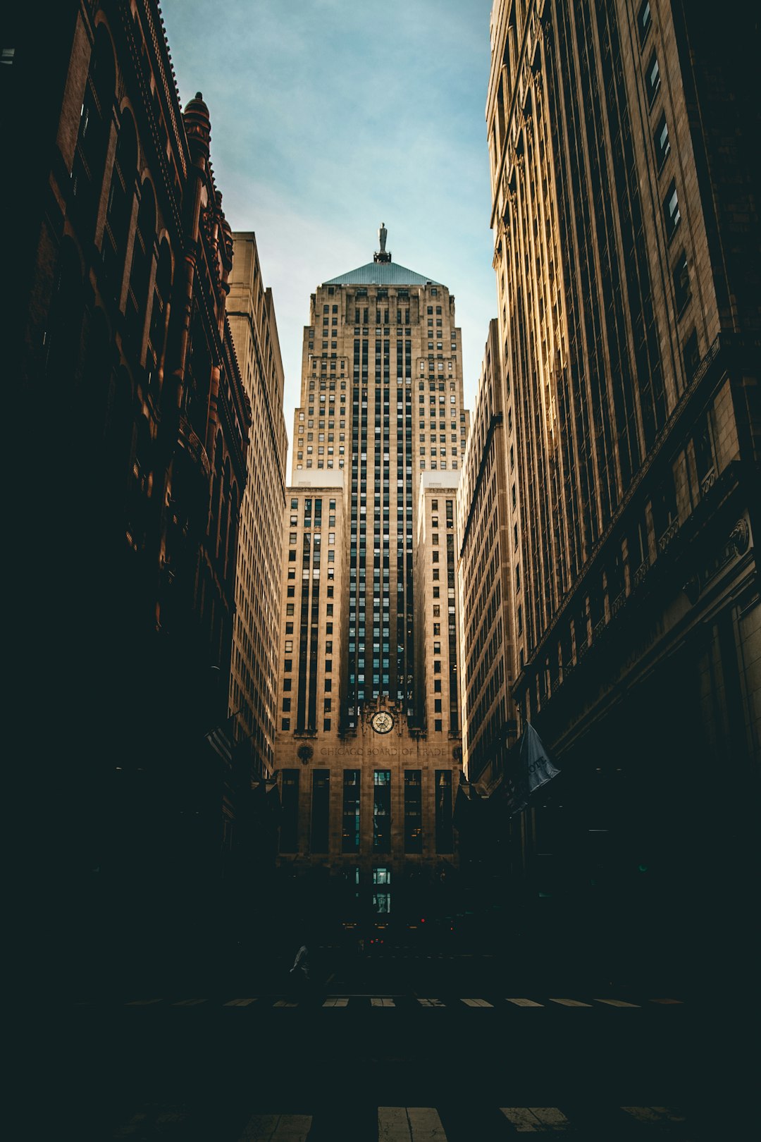 A tall building in the middle of an empty street, skyscraper, photo with a cinematic style, lighting resembling a film, photography resembling a film, photography in the style of cinema, lighting resembling a film –ar 85:128