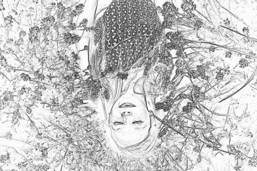 A girl lies on the ground, surrounded by wildflowers and vines, with her head covered in flowers. Her face is hidden behind her hair from an overhead perspective. The drawing style of black ink lines, in the style of , creates a sense of mystery, and the composition focuses on closeup shots of the subject.