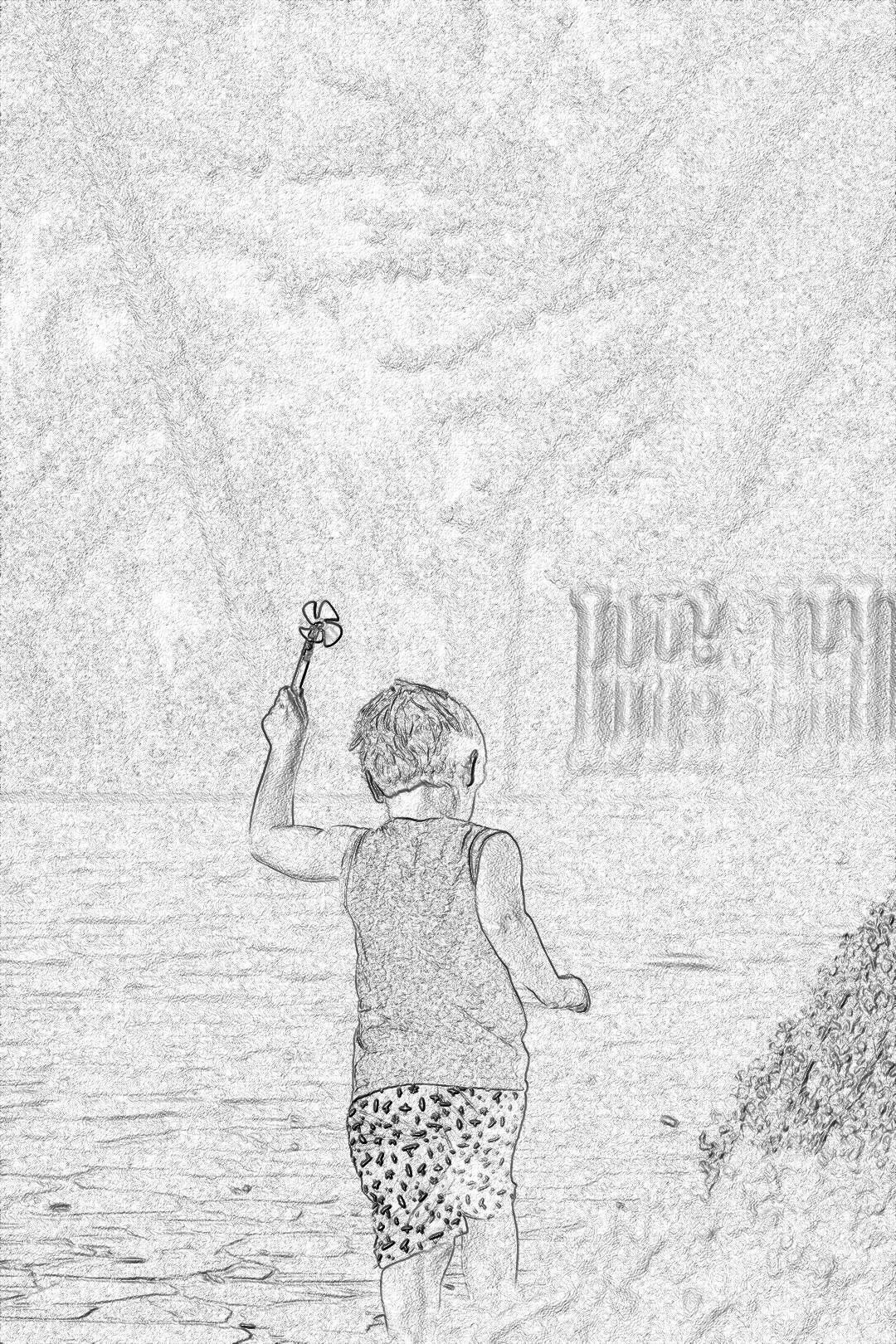 Black and white storyboard sketch of little boy in shorts holding up his hand with an object on it, standing at the beach looking out to sea, background is a pencil drawing style of watercolor