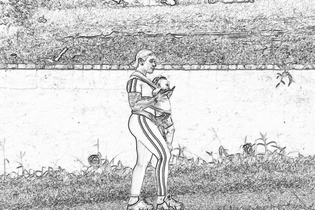 A black and white storyboard sketch of an athletic man wearing long pants standing on the grass holding his baby in one arm while looking at her phone, wall behind him is concrete with horizontal stripes of color,