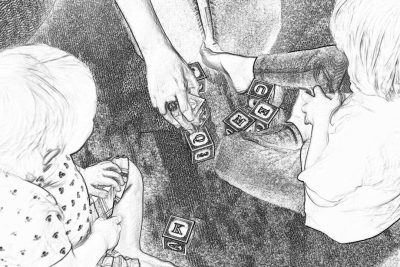 Black and white storyboard drawing of two children playing with letter blocks on the floor, their mother is holding one child's hand