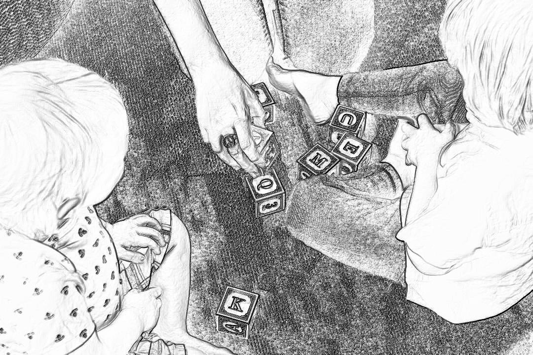 Black and white storyboard drawing of two children playing with letter blocks on the floor, their mother is holding one child’s hand