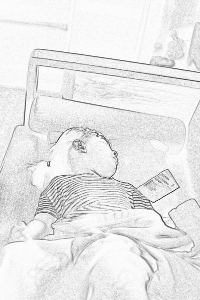 Black and white pencil drawing of baby lying on bed holding phone, bedroom background, simple lines, white paper texture, high contrast, wideangle lens, soft light, smile expression.,in the style of cartoon realism, bold black outlines, simple details, candid moments captured, monochromatic palette, childlike innocence. The drawing is made with a pen tablet using simple line art techniques. It features a cute little boy wearing striped pajamas sleeping in his room while looking at an iPhone screen. He has blonde hair and blue eyes. There's also a book next to him.