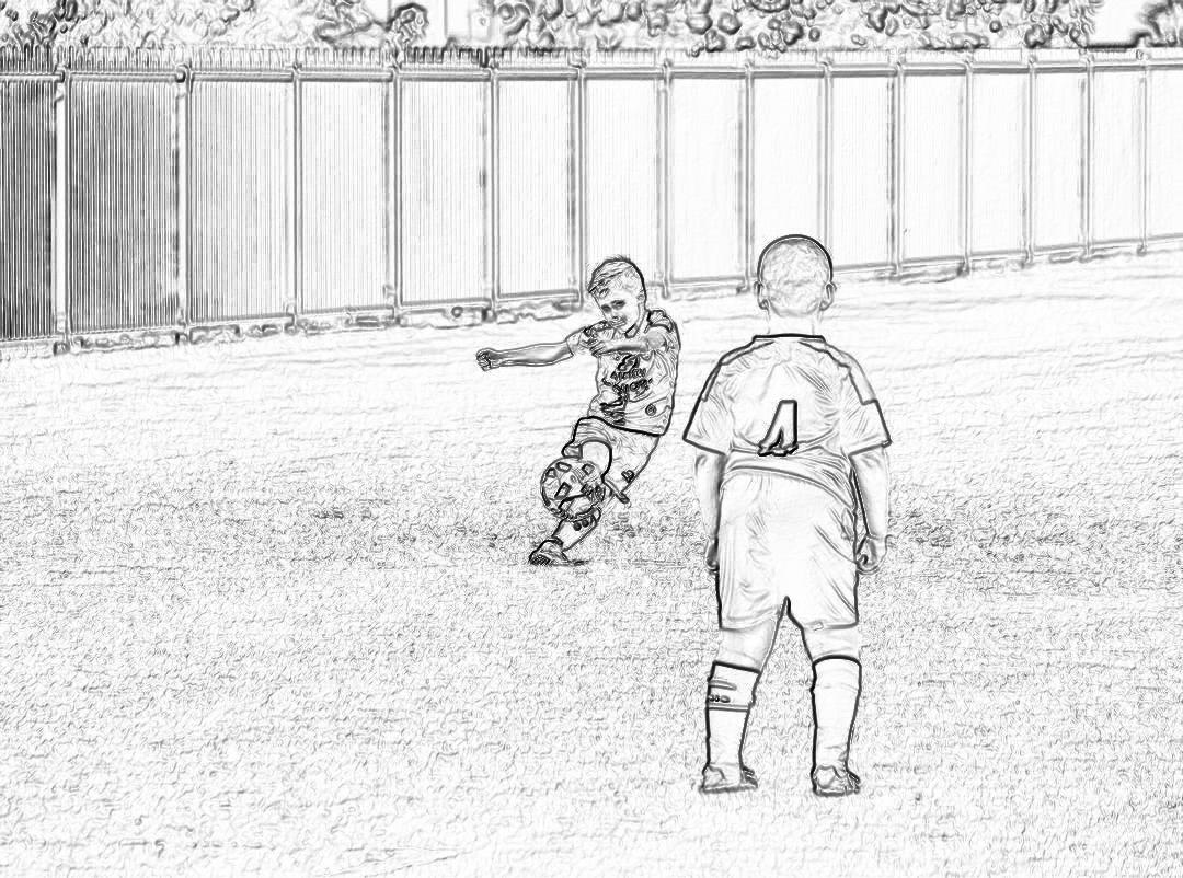 A simple black and white drawing with no shading of two young boys playing soccer on a field at an outdoor stadium. One boy is wearing the number “4”, while another player takes his place behind him to play in their pajamas.