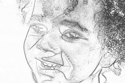 A simple, black and white pencil sketch of an African American woman with short curly hair smiling slightly at the camera. The drawing is drawn in very thick lines, making it look like a child's drawing or doodle. It should have no shading, and only use one line for each facial feature to make them all uniform in thickness. Her eyes appear open wide and her mouth closed as if she was speaking. She has visible teeth in her smile. White background. No text on page.