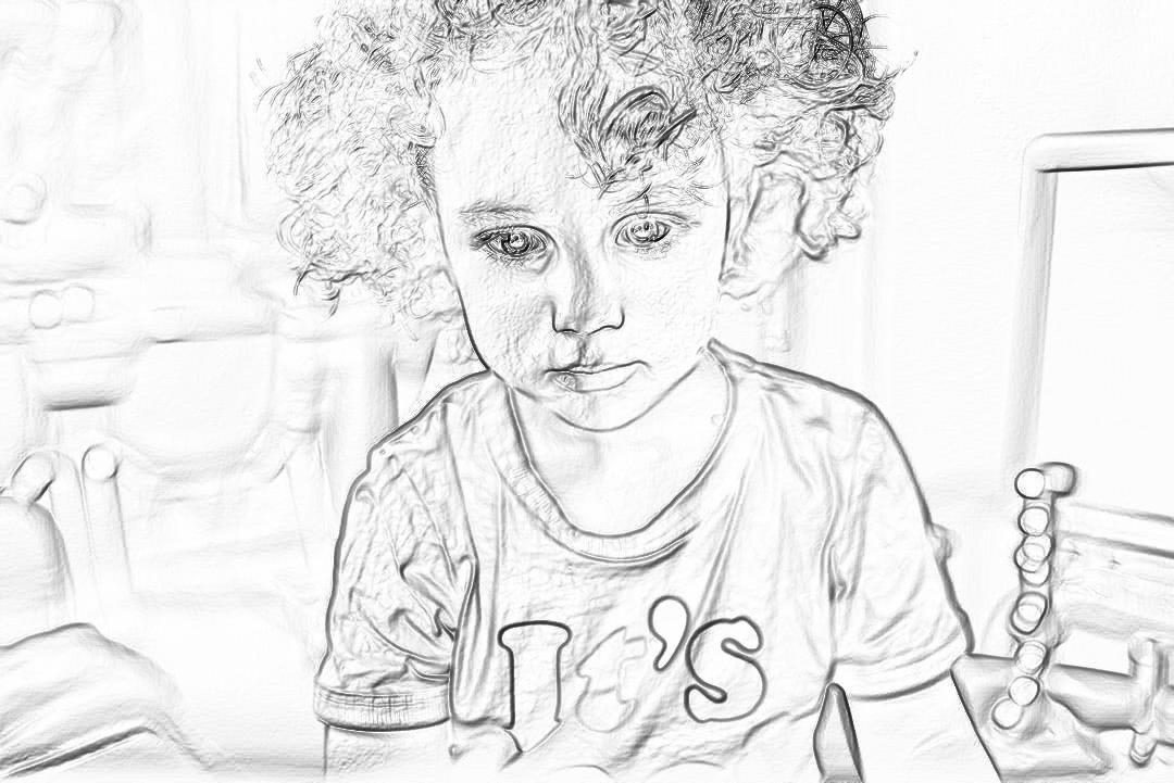 A cute little boy with curly hair, wearing a “gallery” t-shirt and holding toys in his hands sits at the table. The background is white, creating an atmosphere of a black drawing. Black line drawings on paper, sketching, coloring pages, simple lines, soft tones, and soft lighting. The drawing appears to be in the style of a simple black line drawing.