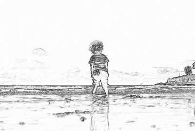 Black and white storyboard line drawing of a little boy with curly hair wearing shorts standing on the beach, playing in shallow water. He has his back to us, seen from behind. The background shows a small hill by a sandy shore.