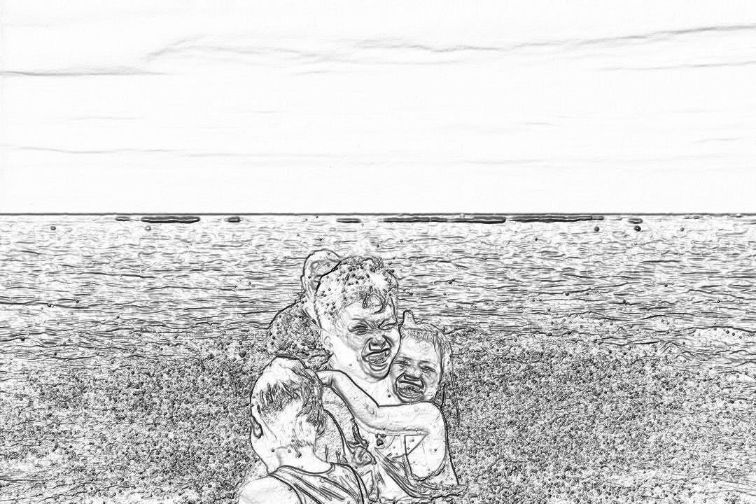 Black and white storyboard line drawing of a mother sitting on the beach with her two children, laughing at them while they play in front of her. The background shows an endless sea. No color. The drawing is in the style of an unnamed artist.