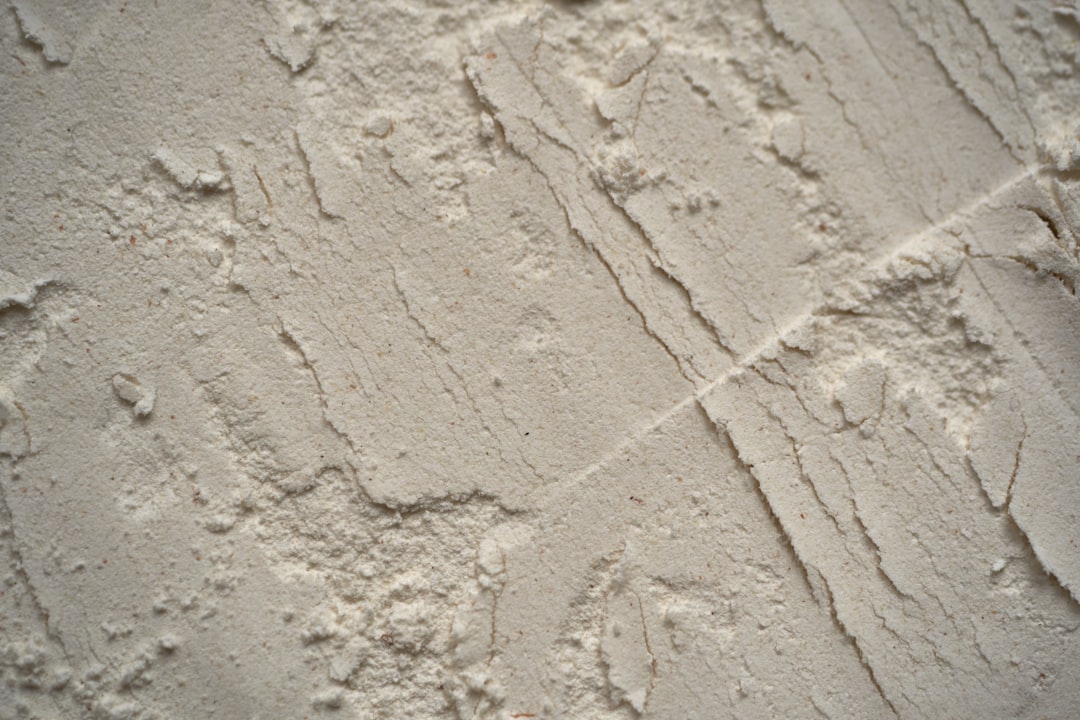 Closeup of wall texture with plaster and rough sand effect, background for interior design or decoration in gray tones. –ar 128:85