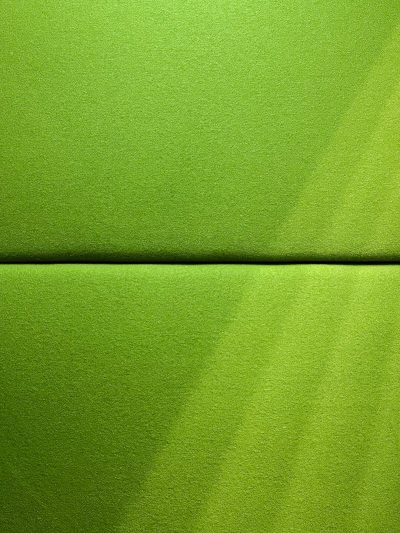 The texture of the lime green felt fabric is very flat, with no wrinkles or folds, and there's an empty space in front for text. The background color should be solid lime green to complement it. There will also be some light shadows on top of each other. This photo was taken using Canon EOS R5 camera with standard lens. It has high resolution and fine details. --ar 3:4