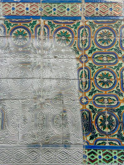 A closeup of the intricate patterns on an ancient tile wall, showcasing the beauty and complexity found in Islamic art. The colors include shades of blue, green, white, silver, yellow, orange and red. --ar 3:4